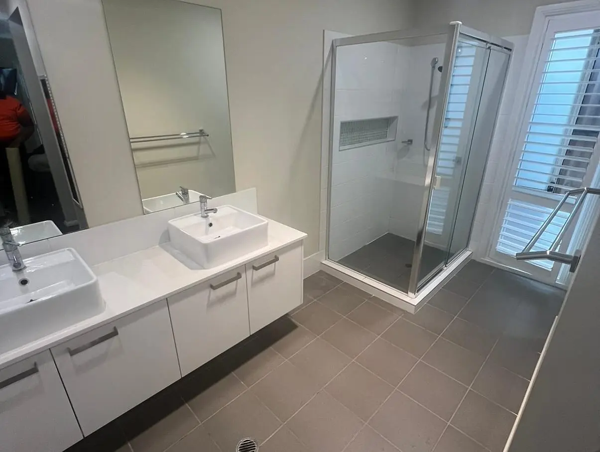 Bathroom before renovation with a white vanity