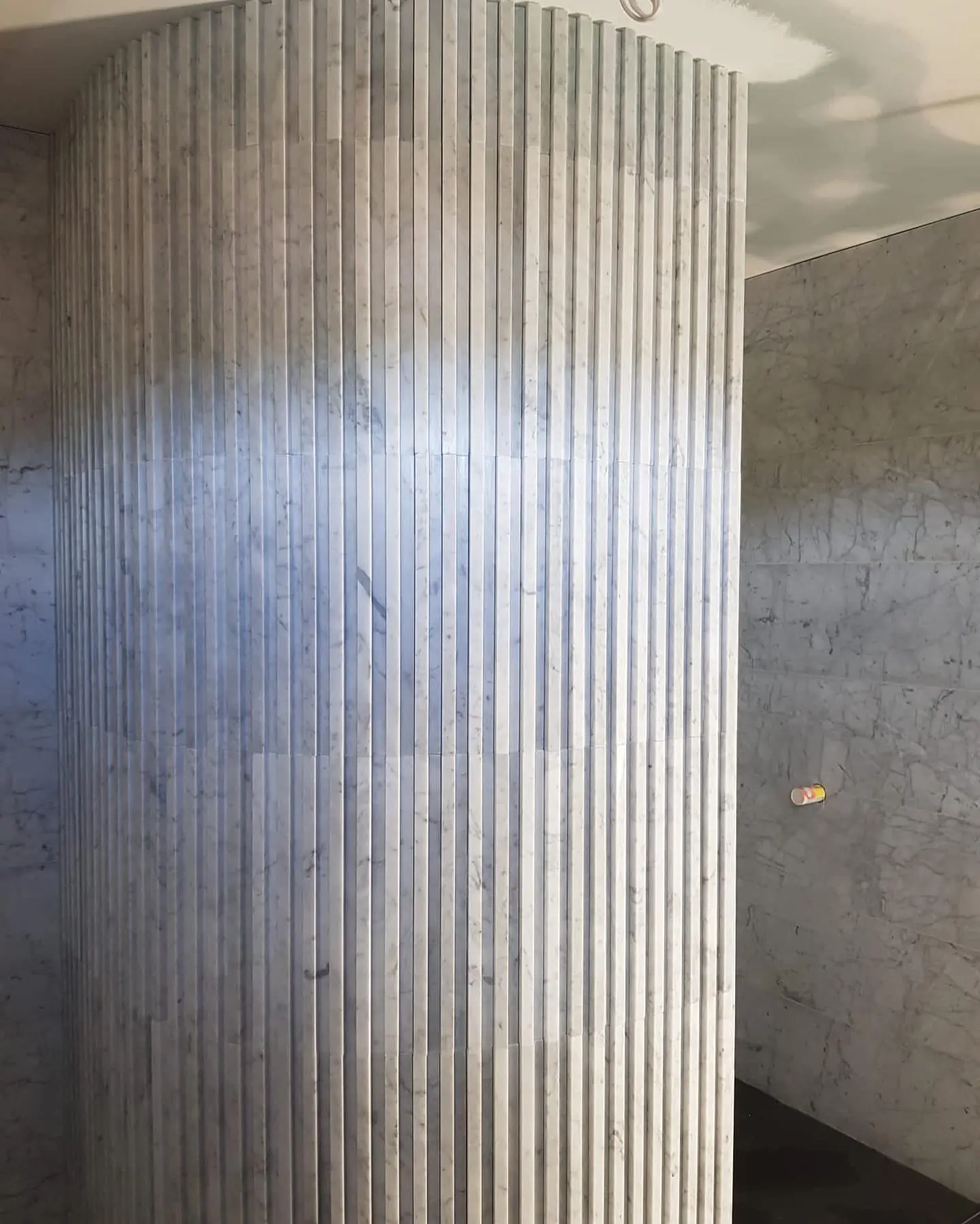 Curved stone tile detail during a bathroom renovation