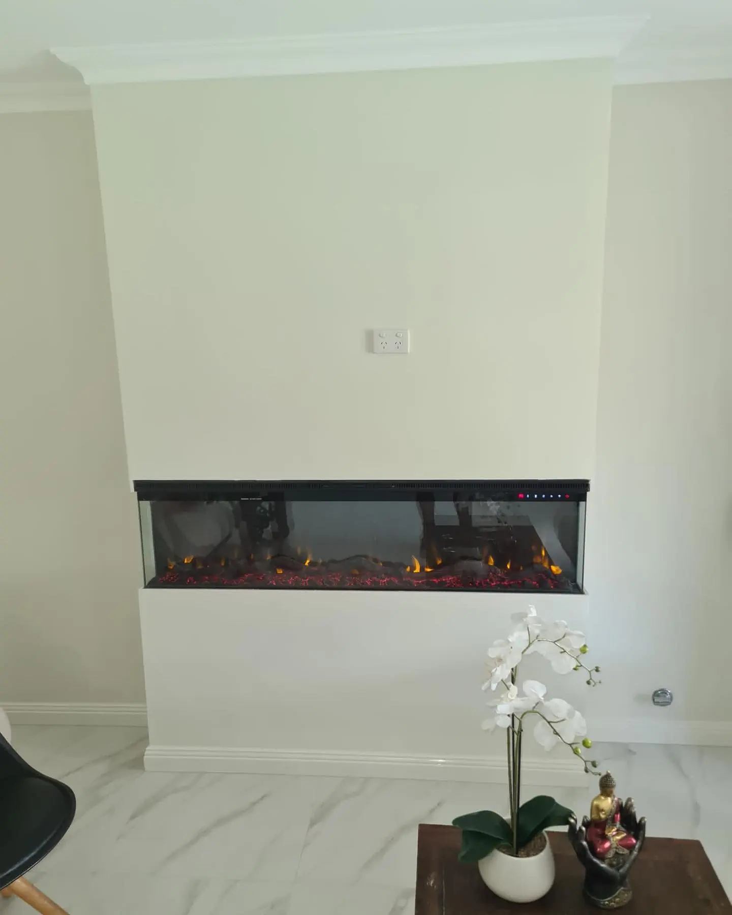 Completed fireplace set into a finished white wall