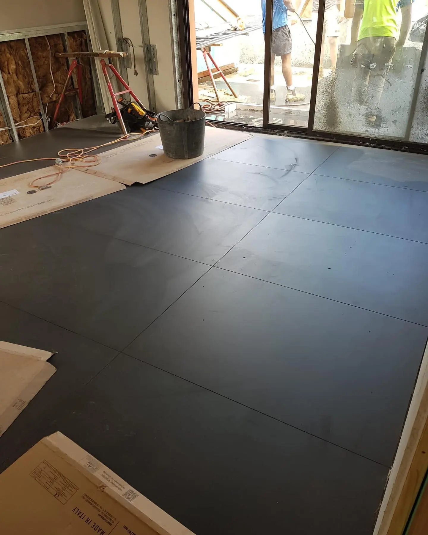 Large format floor tiles during an interior renovation