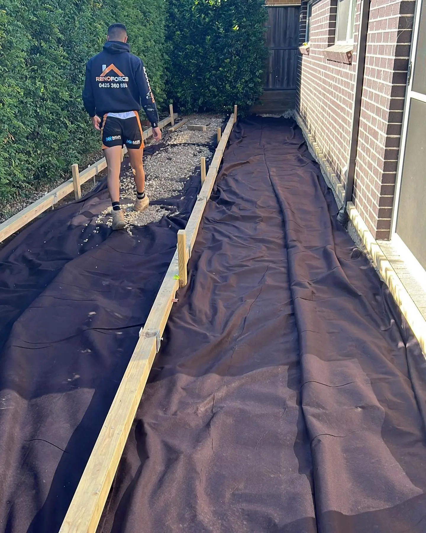 Renoforce building the frame for a garden deck