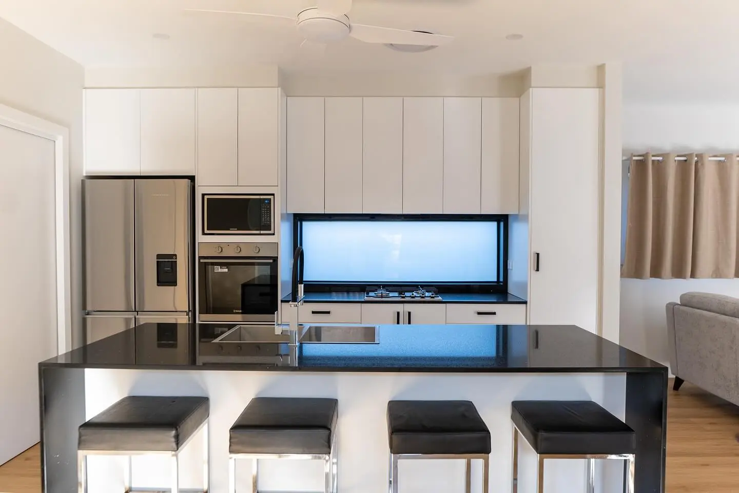 Completed granny flat kitchen with an island and contrasting cabinetry