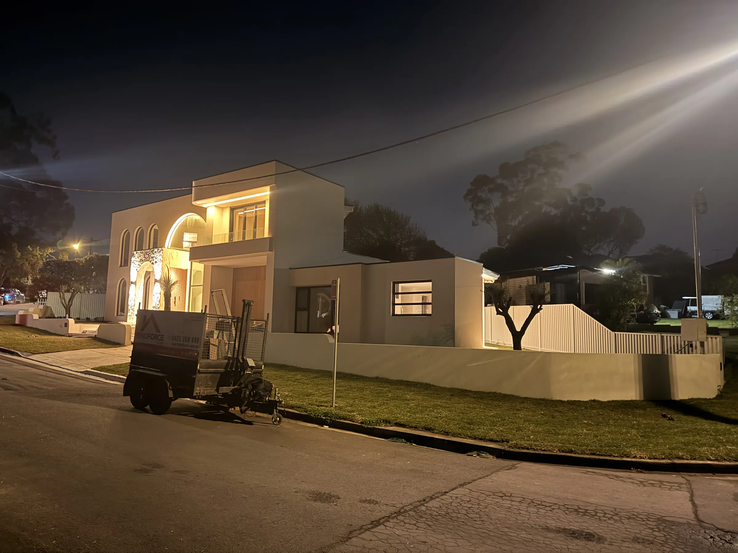 Street view of the illuminated residence in the evening