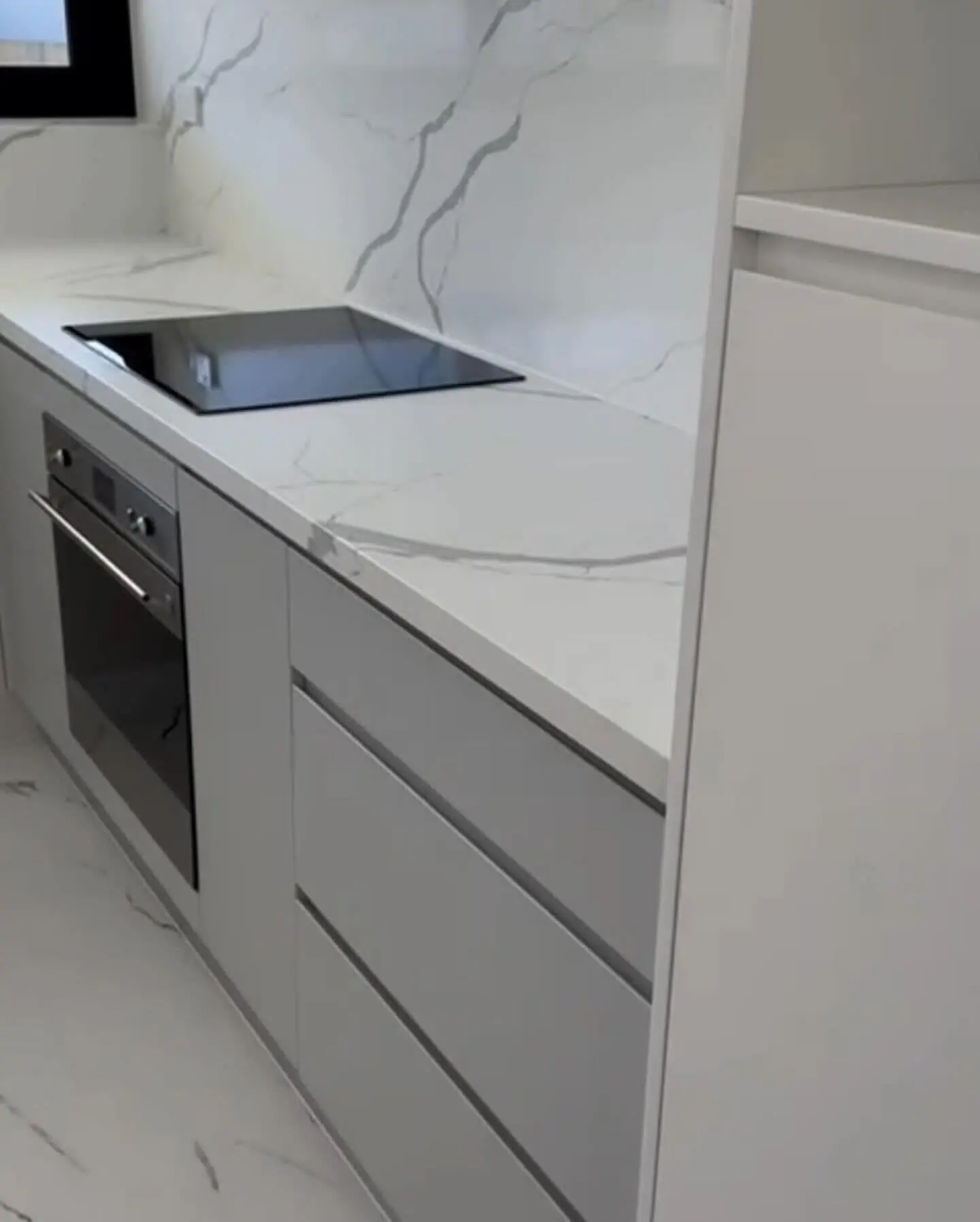 Cooktop and stone splashback in a renovated unit